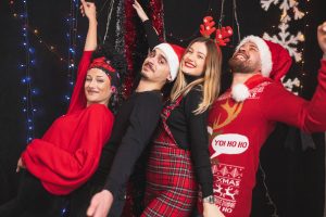 A group of colleagues dressed in festive outfits