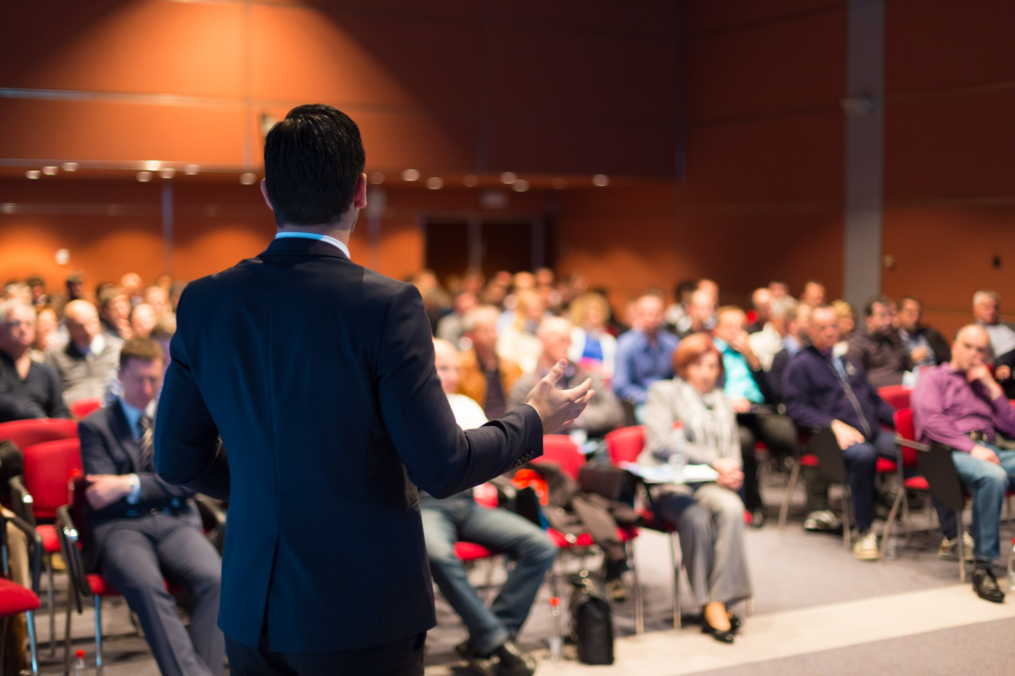 Business speaker presenting to audience at professional conference event