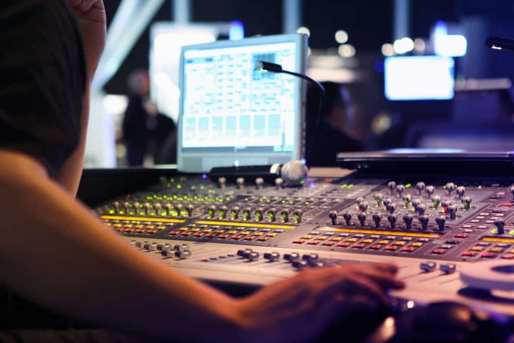 Audio engineer operating sound mixer at live event