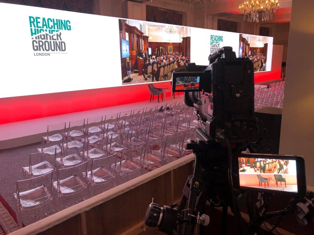 Conference stage with large LED screen and camera setup