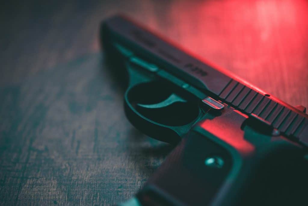 Handgun on table with dramatic lighting for crime scene