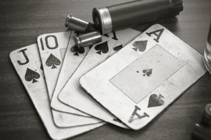 Playing cards and bullets symbolising gambling crime scene