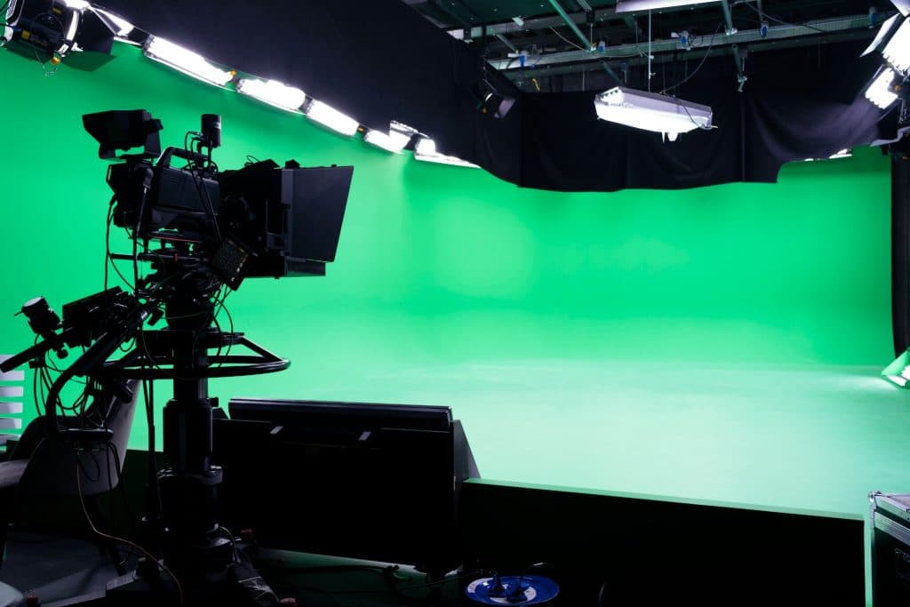 Green screen studio setup with professional lighting and camera equipment