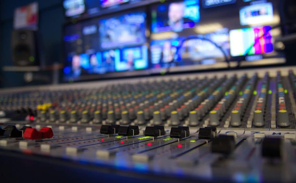 Professional audio mixing desk in broadcast studio control room