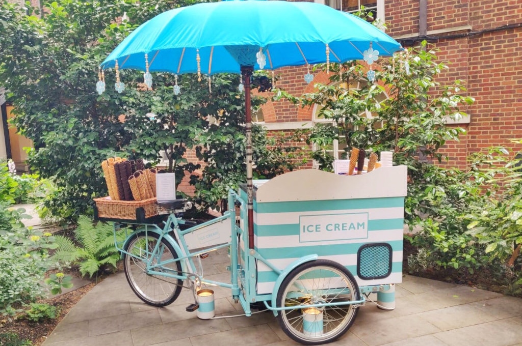 Vintage ice cream tricycle cart with blue parasol